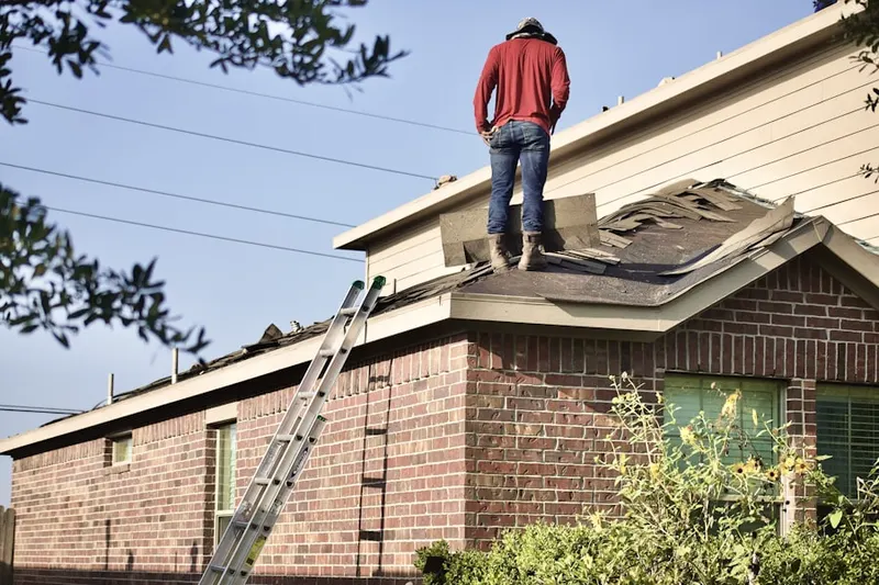 Professional roofer working on a residential roof in Mansfield Hollow